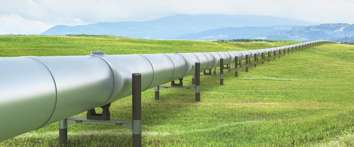 pipeline in the summer time on green grass and blue sky